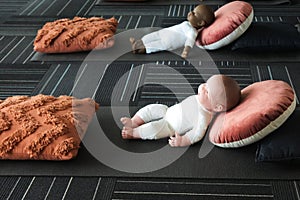 Two different baby boy dolls toys lying on the floor