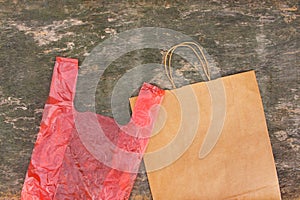 Two different bags of paper and polyethylene on an old wooden background.