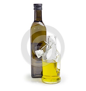 Two different bottle of olive oil on a white background