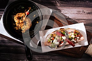 Two different and clasical Spanish tapas on a rustic table with a dark background. traditional spanish cuisine photo