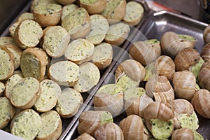 Two different displays of escargots de Bourgogne at caterer