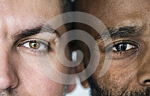 Two different ethnic men`s eyes closeup