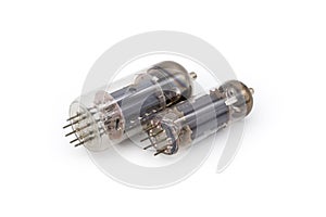 Two different old electronic vacuum tubes on a white background