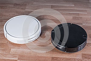 Two different Robotic vacuum cleaners, efficient dust absorption in absence of householder, modern smart appliance for cleaning