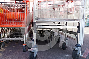 Two different type of shopping carts, in a row stocked to one another