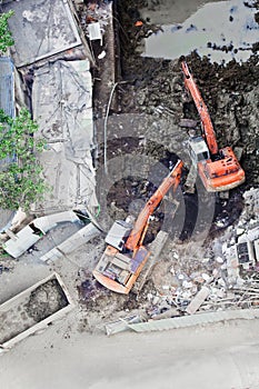 Two diggers moving soil onto truck photo