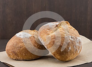 Two Dinner Rolls on Brown Paper