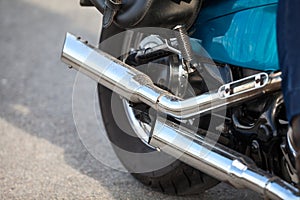 Two direct exhaust pipes on chopper motorcycle, chrome loud sound silencer