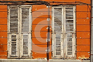 Two Dirty Wooden Closed Shutters In The Old Building Facade