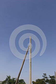 Two Disabled Electric Pole 1 With a Blue Sky Minimalism Background