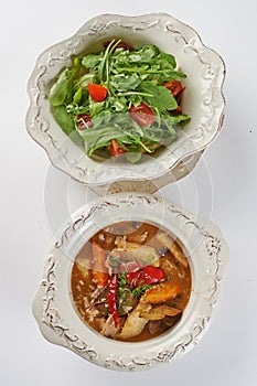 Two Dishes on Plates Served Simultaneouly