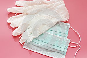 Two disposable medical masks and a pair of latex gloves