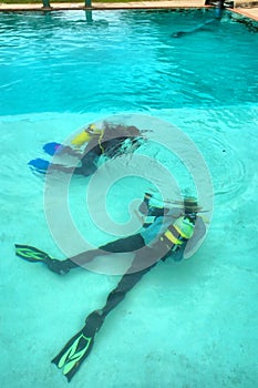 Two divers in training pool