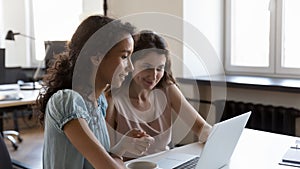 Two diverse employees working on project tasks together