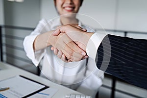 Two diverse professional business executive leader shaking hands at office after meeting