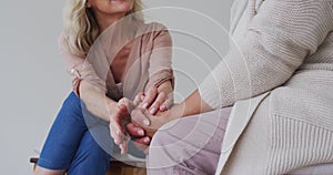 Two diverse senior couples sitting in circle having a therapy conversation at home