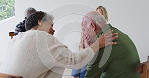 Two diverse senior couples sitting in circle having a therapy conversation at home