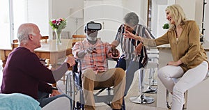 Two diverse senior couples sitting on a couch disabled african american man is using vr googles