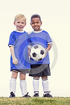 Two diverse young soccer players holding a soccer ball