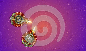 Two diwali lamps and glitters