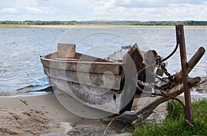 Two docked wooden boats on the lake shore