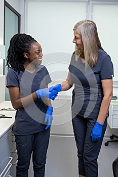 Two doctor colleagues discussing something during changeover in a clinic photo