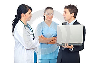 Two doctors and businessman having conversation
