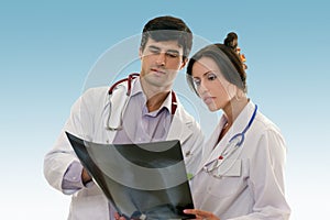 Two doctors conferring over x-ray results