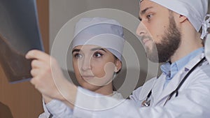 Two doctors consider a patient of x-ray picture
