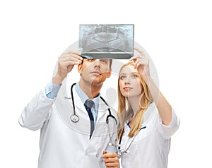 Two doctors dentists looking at x-ray photo