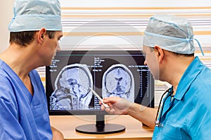 Two doctors examining an MRI scan