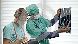 Two doctors examining x-ray images of patient for diagnosis. Concept of the absence of interracial contradictions in a