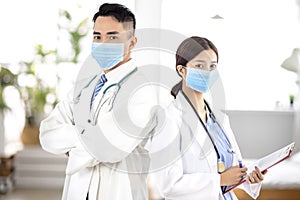 Two doctors faces wearing protective mask in Hospital