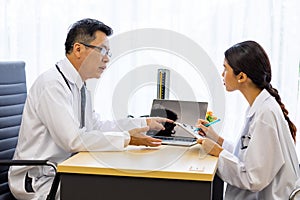 Two doctors in the hospital discuss