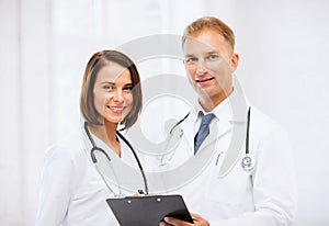 Two doctors with stethoscopes photo