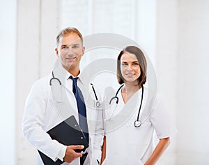 Two doctors with stethoscopes photo