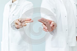 two doctors wiping with fingers, space for interactive themes