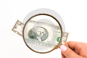 Two dollars bill and magnifying glass