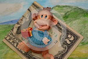 Two dollars money and monkey gift green background