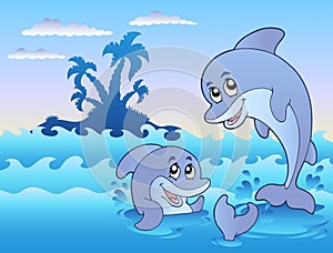 Two dolphins playing in waves