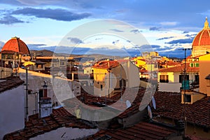 The two domes and colorful rooftops at sunset