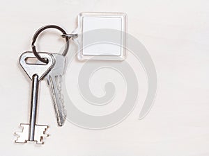 Two door keys on keyring with blank white keychain