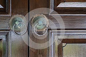 Of two doorknobs on a front door photo