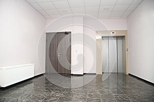 Two doors of elevators in modern business building.