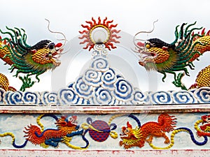 two dragon mosaic on roof and sun beam lantern