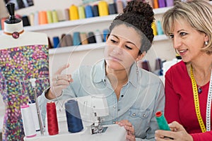 Two dressmakers in their workshop photo