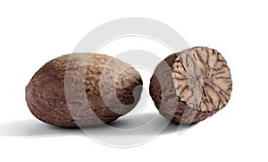 Two dried nutmegs, a whole and a half.