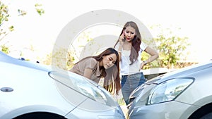 Two drivers check for damage after a car accident before taking pictures and sending insurance. Online car accident insurance