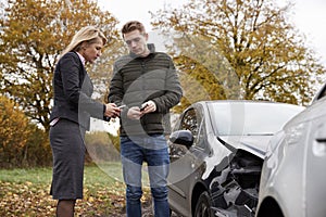 Two Drivers Exchanging Insurance Details After Car Accident