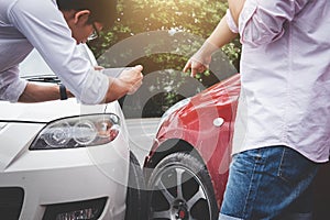Two drivers man arguing after a car traffic accident collision a